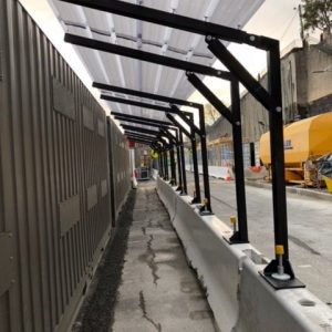 Walkway-cover-connecting-to-anchors-on-Jersey-Barriers-2-e1568344263123.jpg